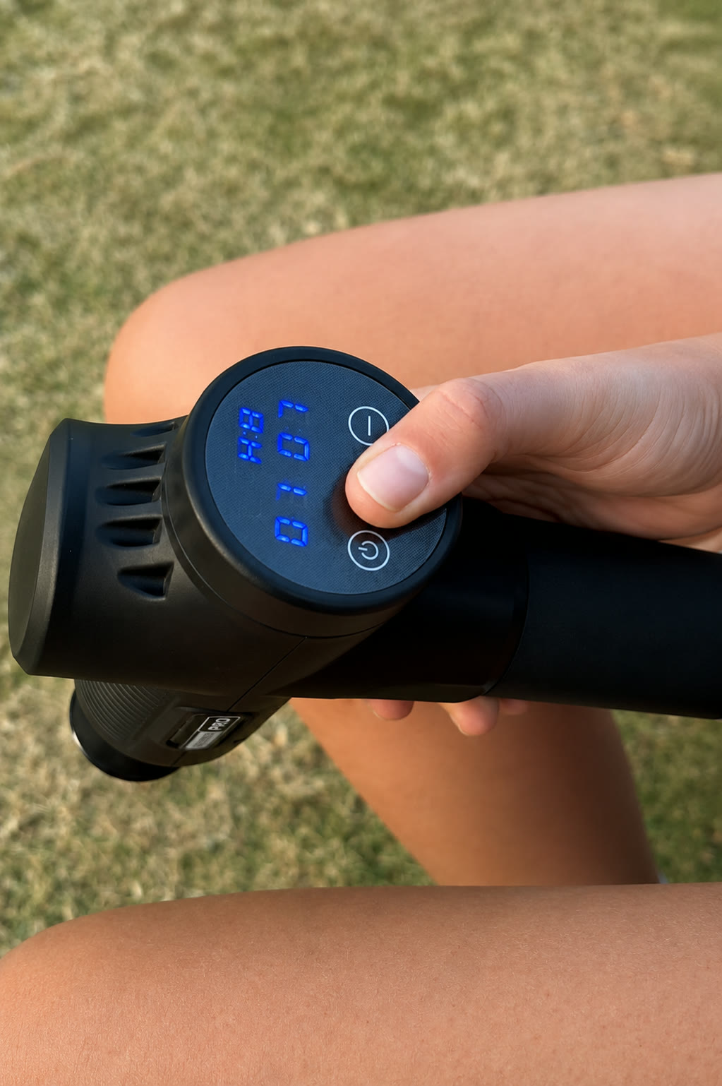 Hand adjusting the Recover Pro control panel while using it on the leg